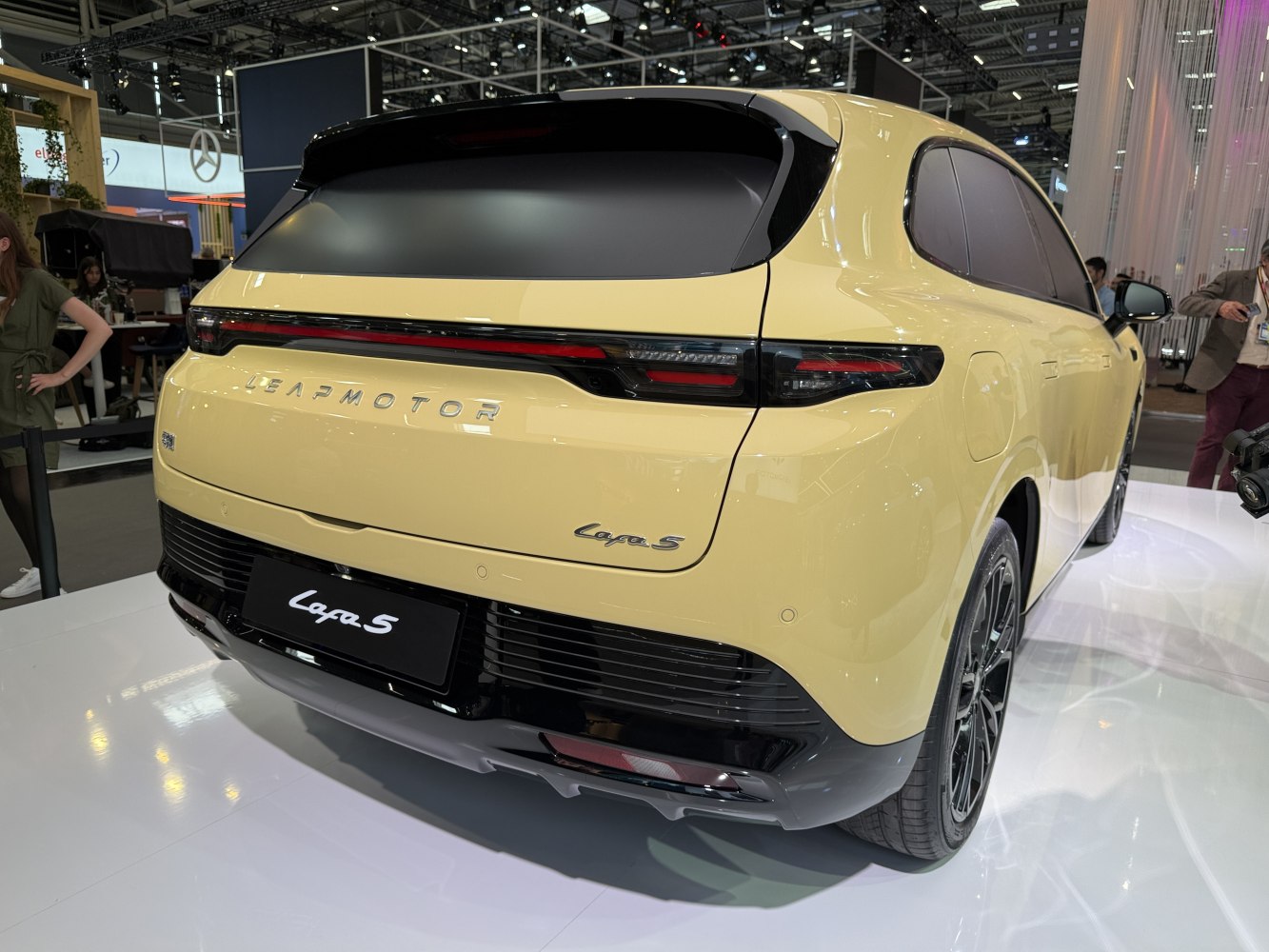 Rear view of a modern electric SUV with sleek tail lights and black trim.