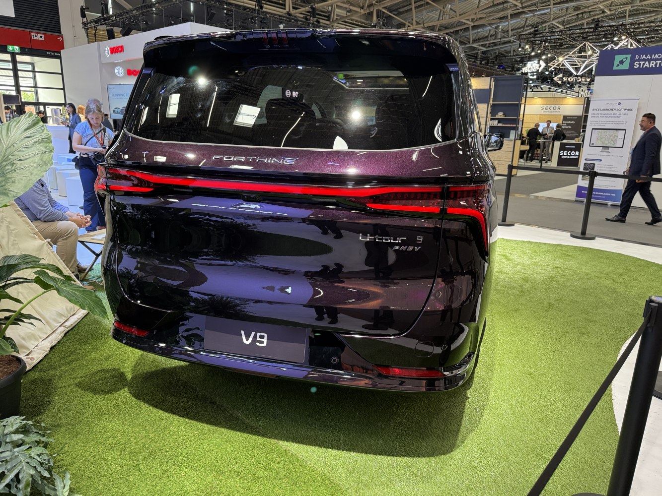 Sleek LED tail lights and rear branding on the vehicle