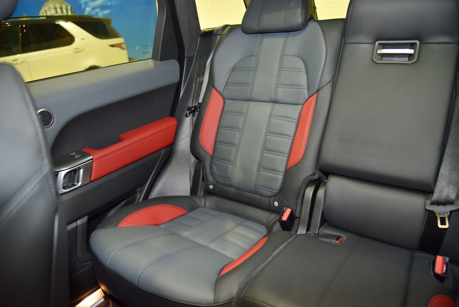 Black and red leather rear seats with detailed stitching