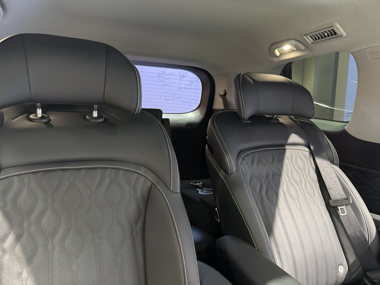 Black leather front seats with ergonomic headrests and detailed stitching