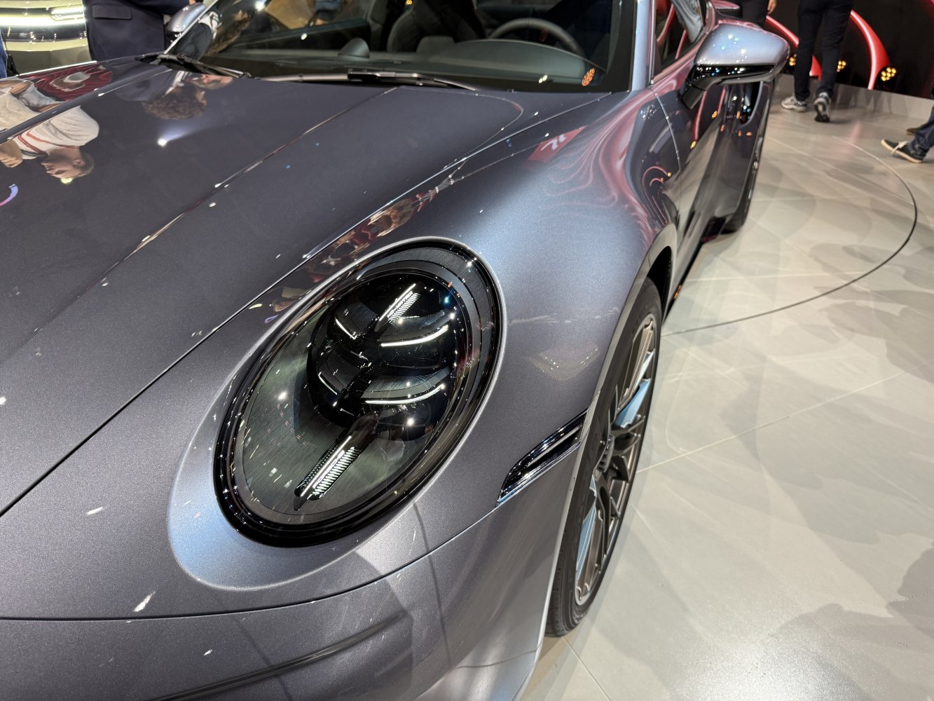Close-up of Porsche 911 front headlight and hood design