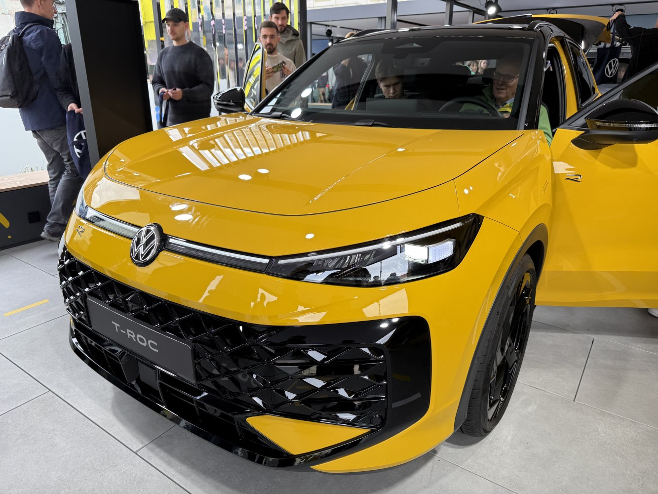 Yellow SUV front with distinctive grille and LED headlights