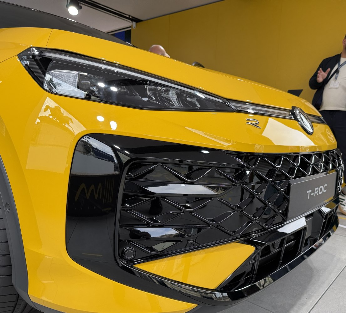 Front headlight and grille detail of a yellow compact SUV