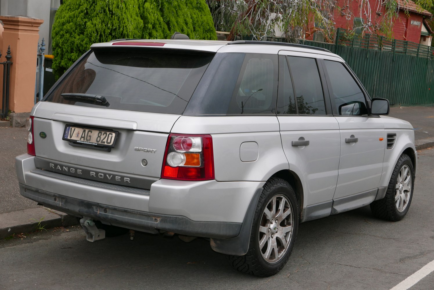 Rear view of a classic Range Rover Sport SUV with distinct taillights and trailer hitch