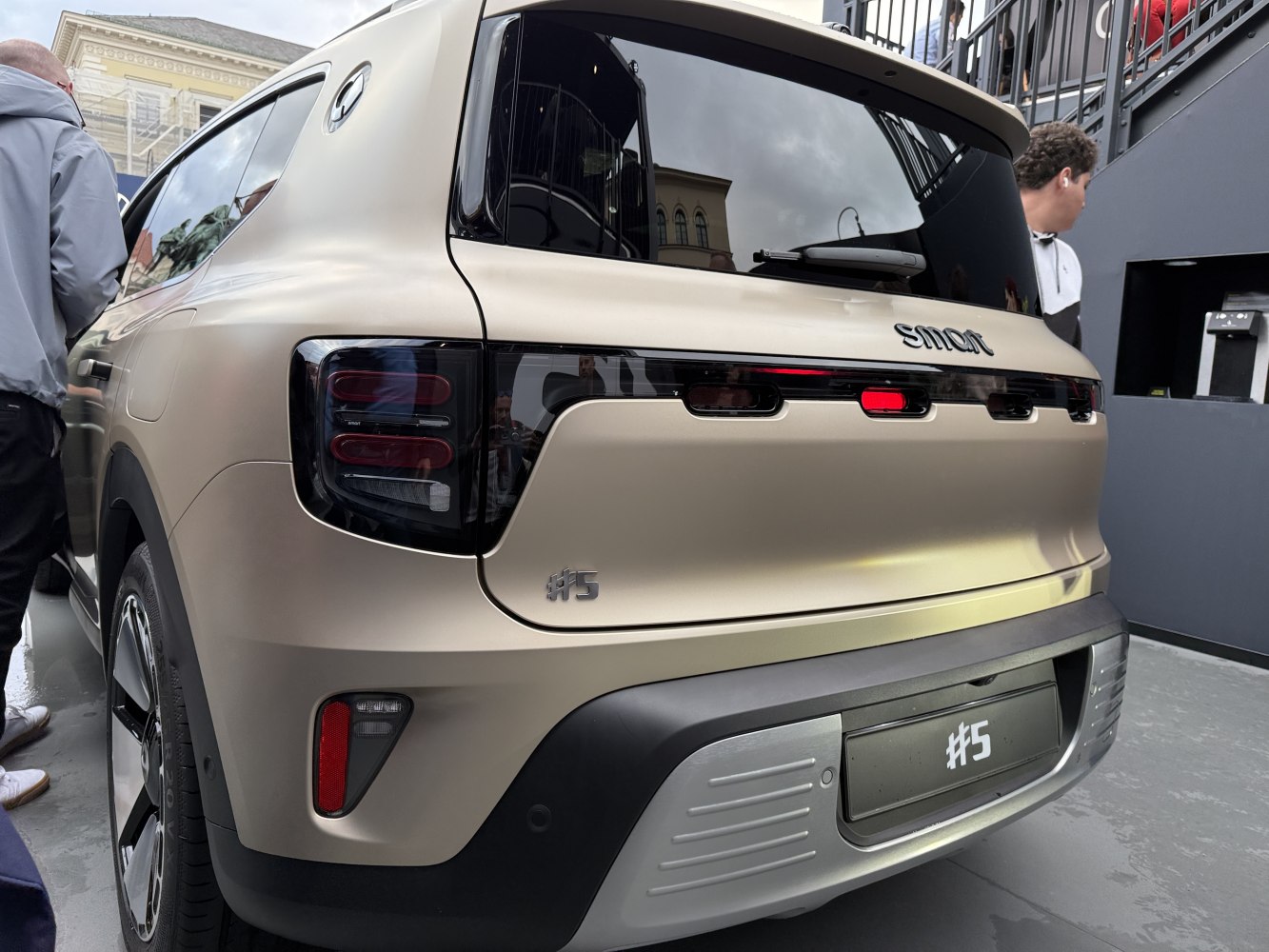 Rear view of electric SUV with distinctive tail lights and #5 badge