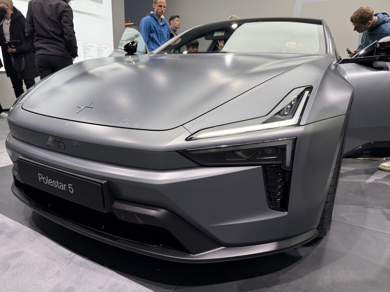 Front fascia and sharp LED headlights of a modern electric sedan