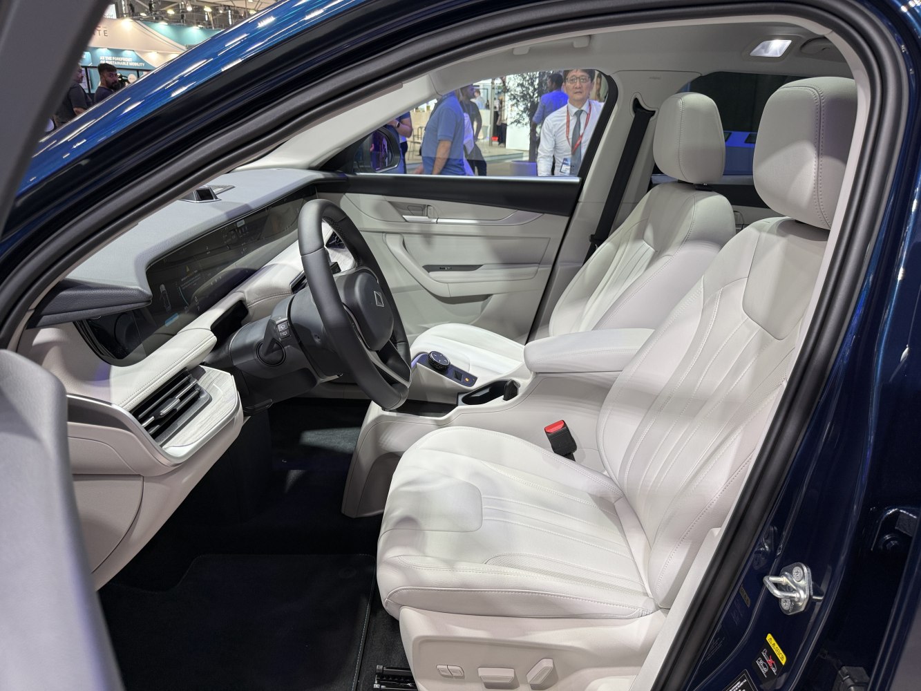 White leather seats and advanced dashboard inside modern vehicle