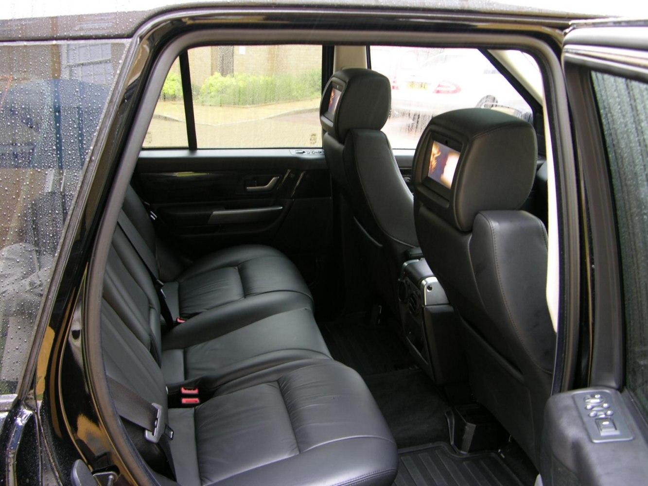 Rear seat entertainment screens with black leather seating