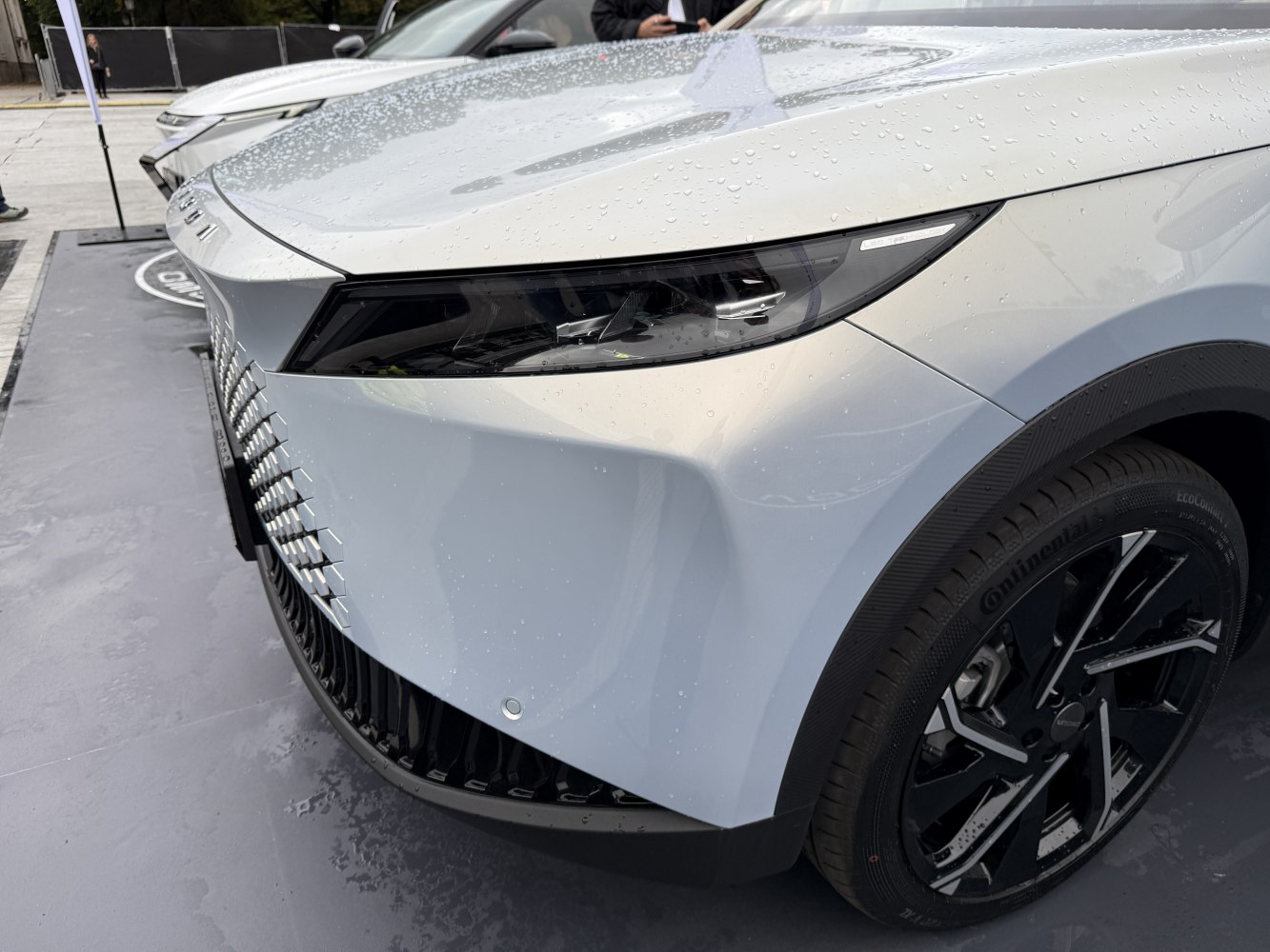 Close-up of front headlight and alloy wheel on a modern vehicle