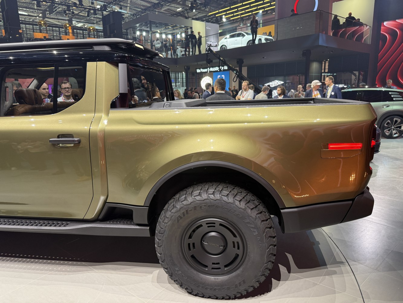 Rear side and truck bed with rugged off-road tires and sleek design.