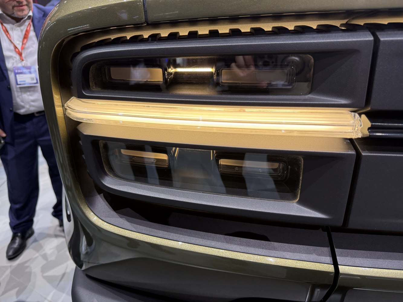 Close-up of unique front headlight assembly with LED strip.