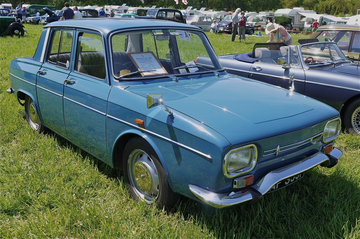 Vintage blue four-door sedan with chrome bumpers and retro side mirrors