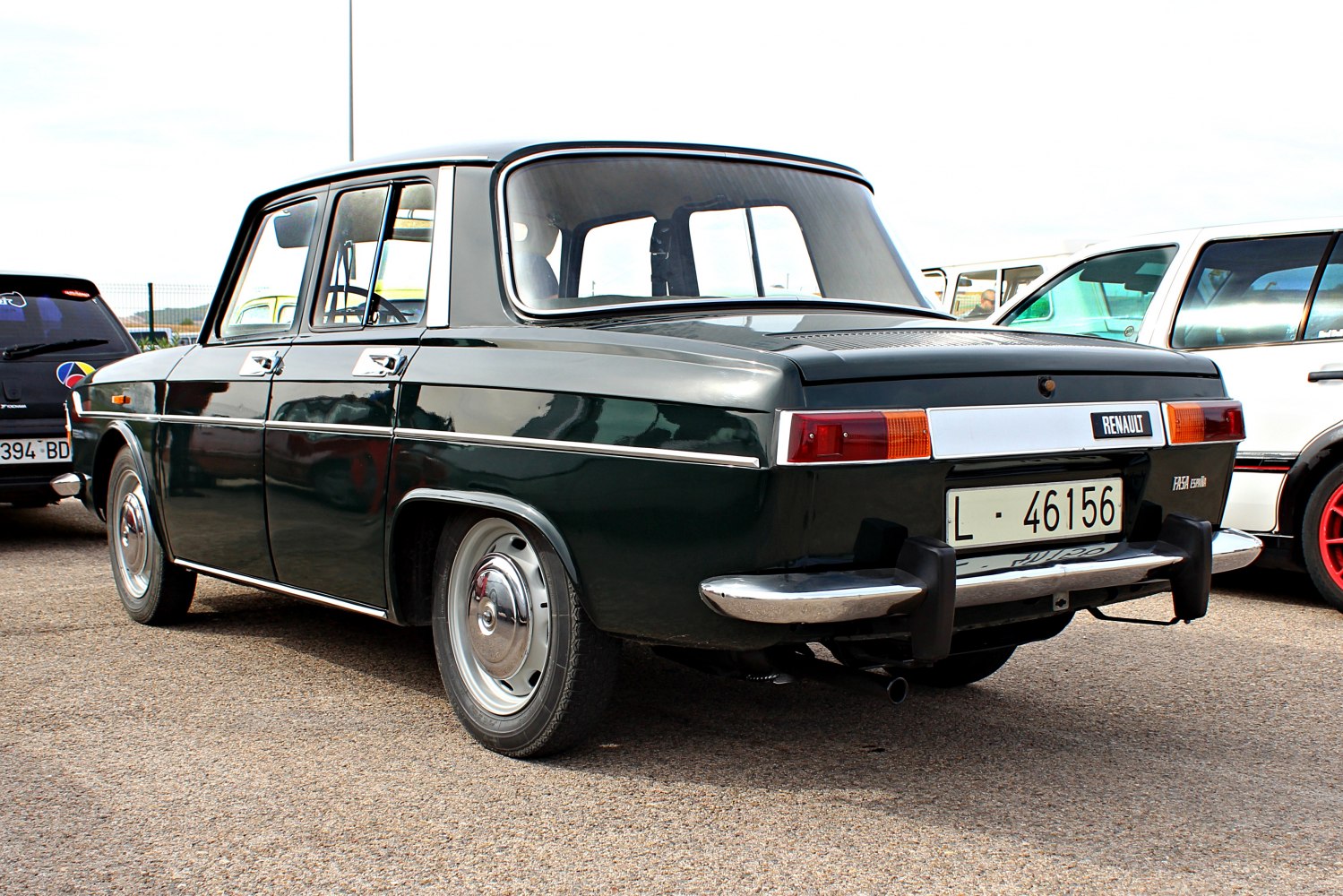 Rear view of a classic car with chrome bumpers and rectangular tail lights.