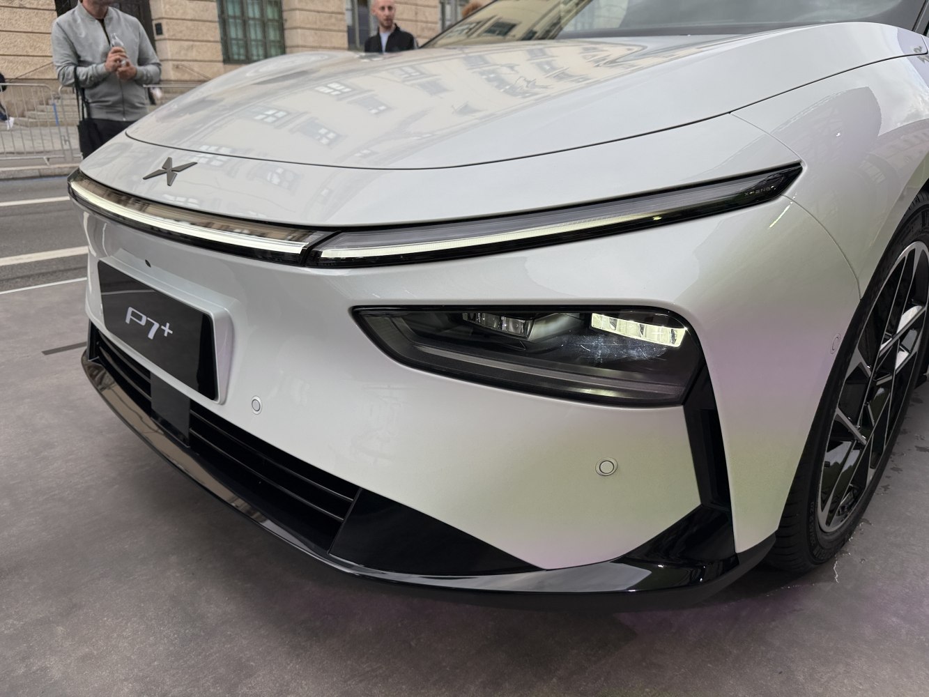 Front LED headlights and aerodynamic design of a sleek white vehicle