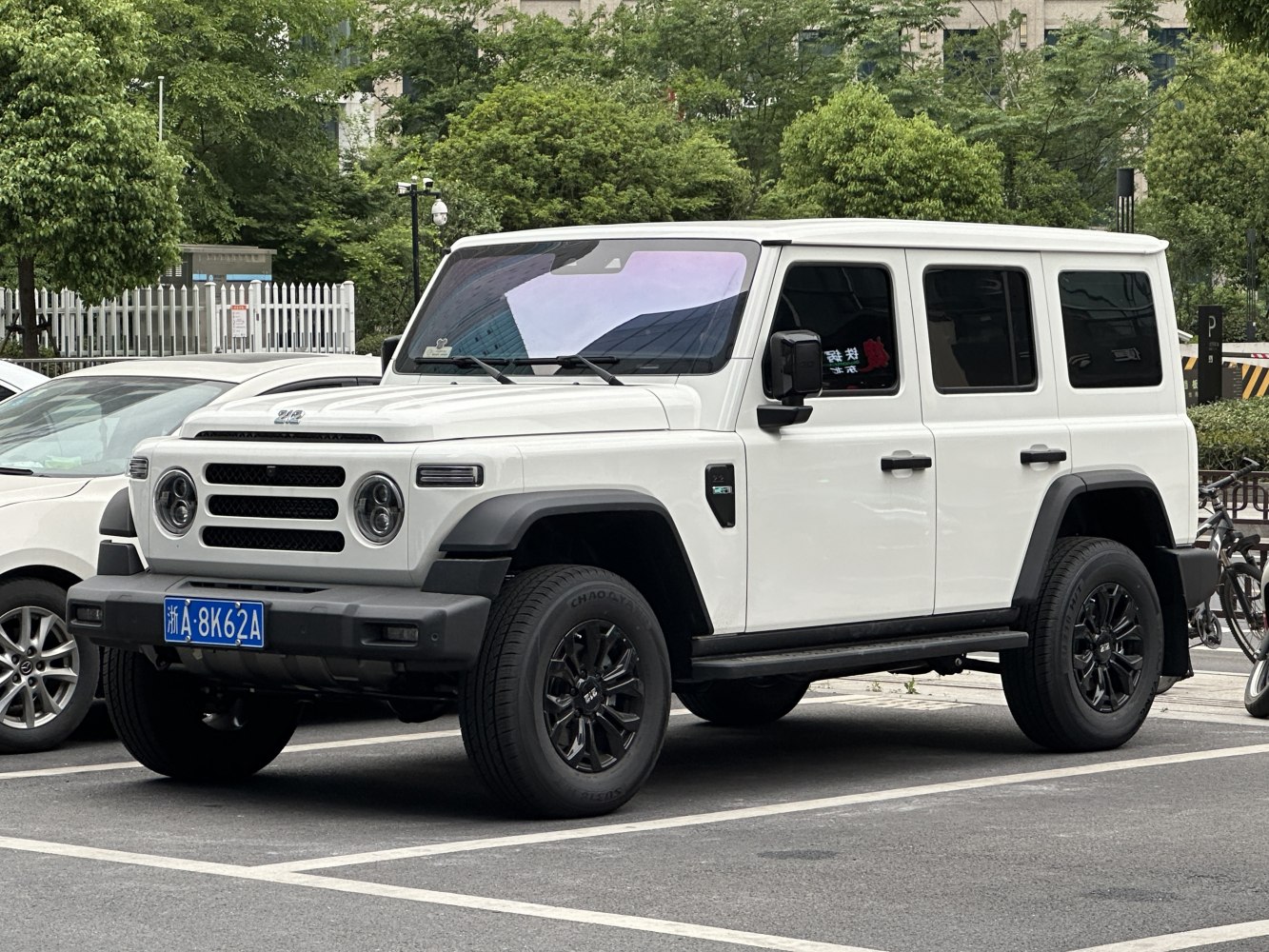 Boxy 4-door SUV with round headlights and black wheels