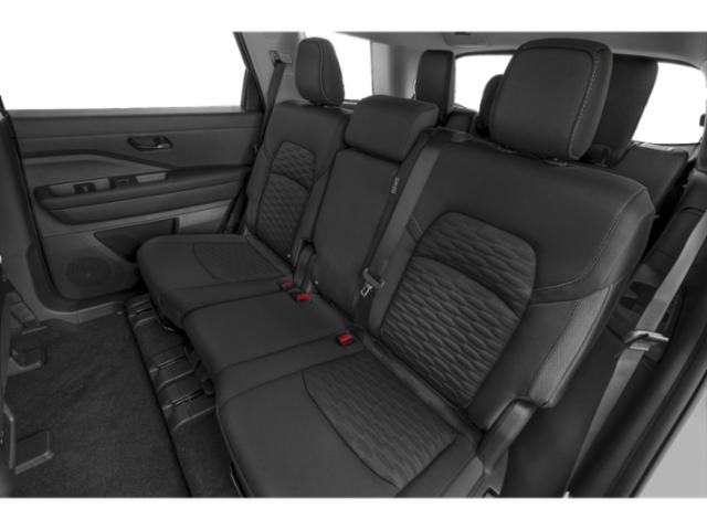 Rear seat interior with black leather and textured upholstery in an SUV