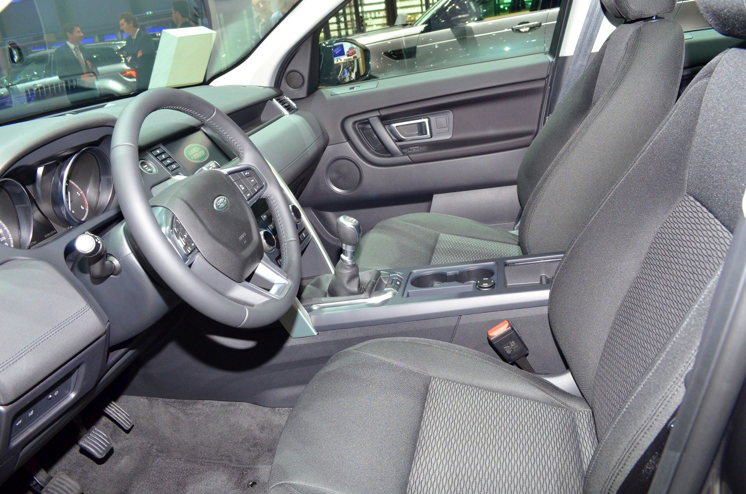 Steering wheel, dashboard, gear shift, and front seats interior view
