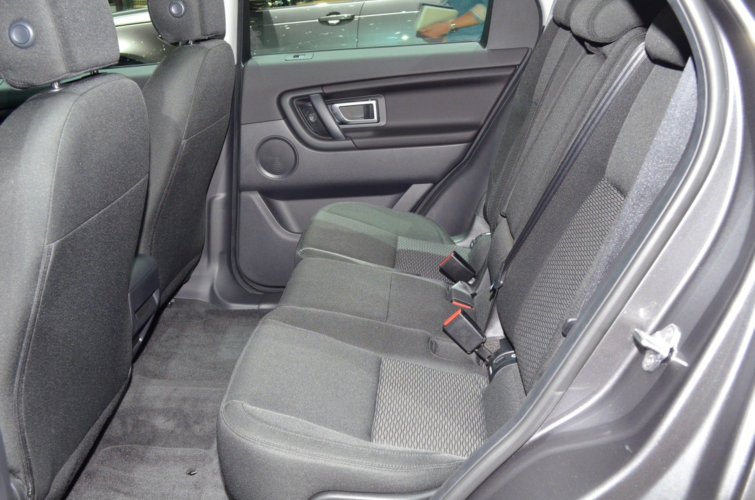 Spacious rear seat with fabric upholstery and rear door panel.