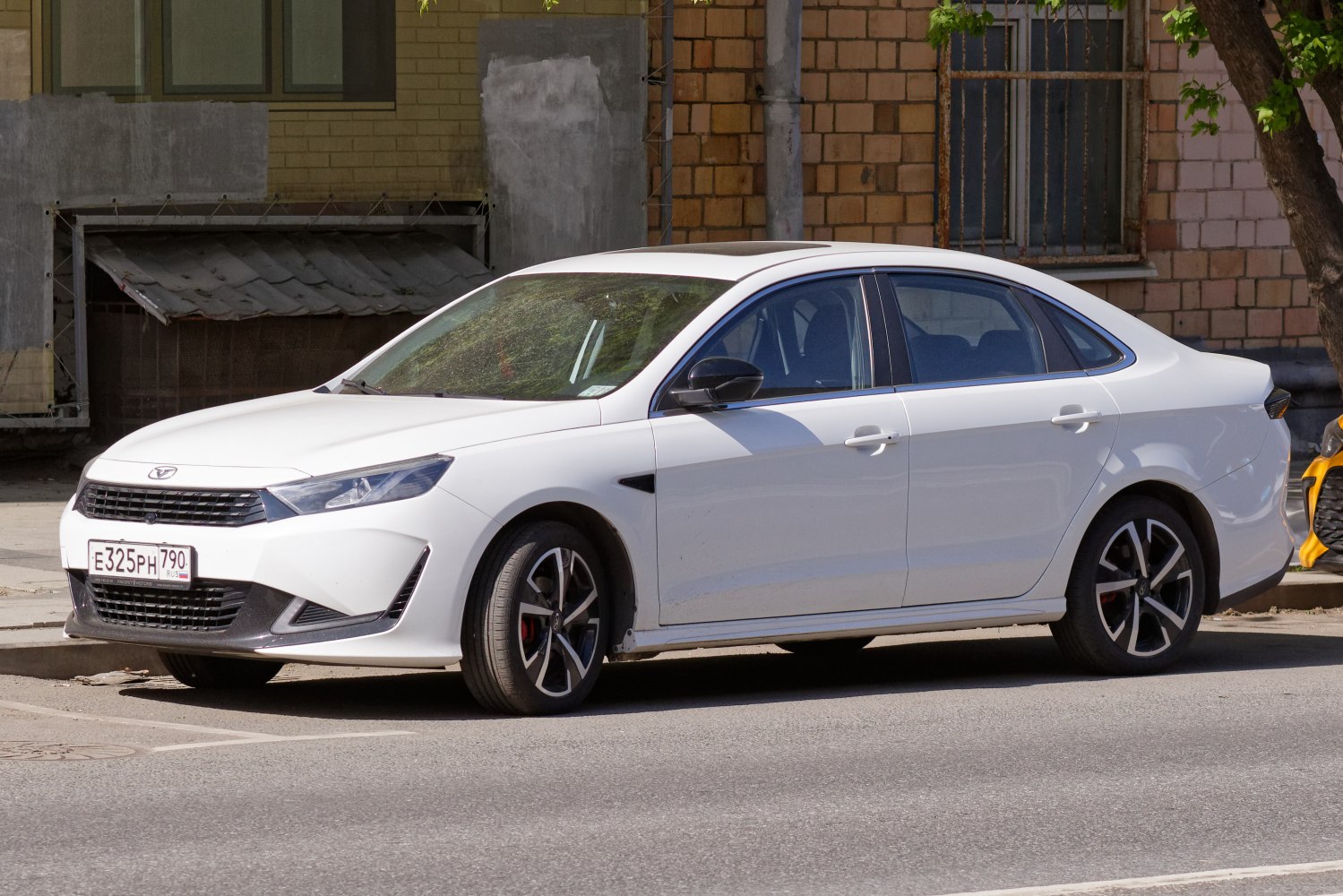 White sedan with angular headlights and sporty alloy wheels