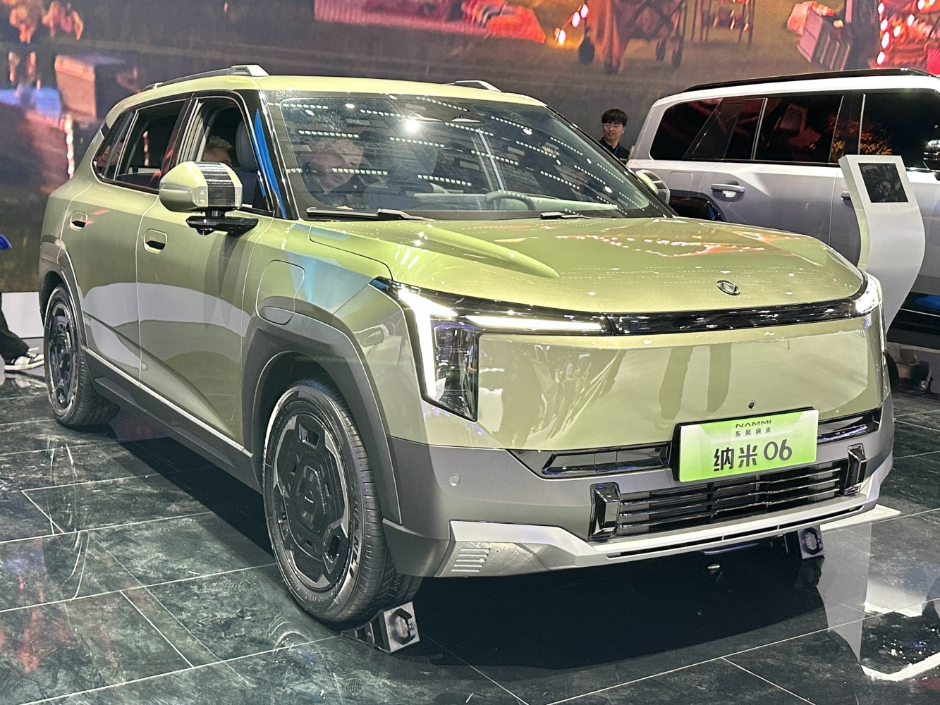 Compact electric SUV front with distinctive vertical LED headlights