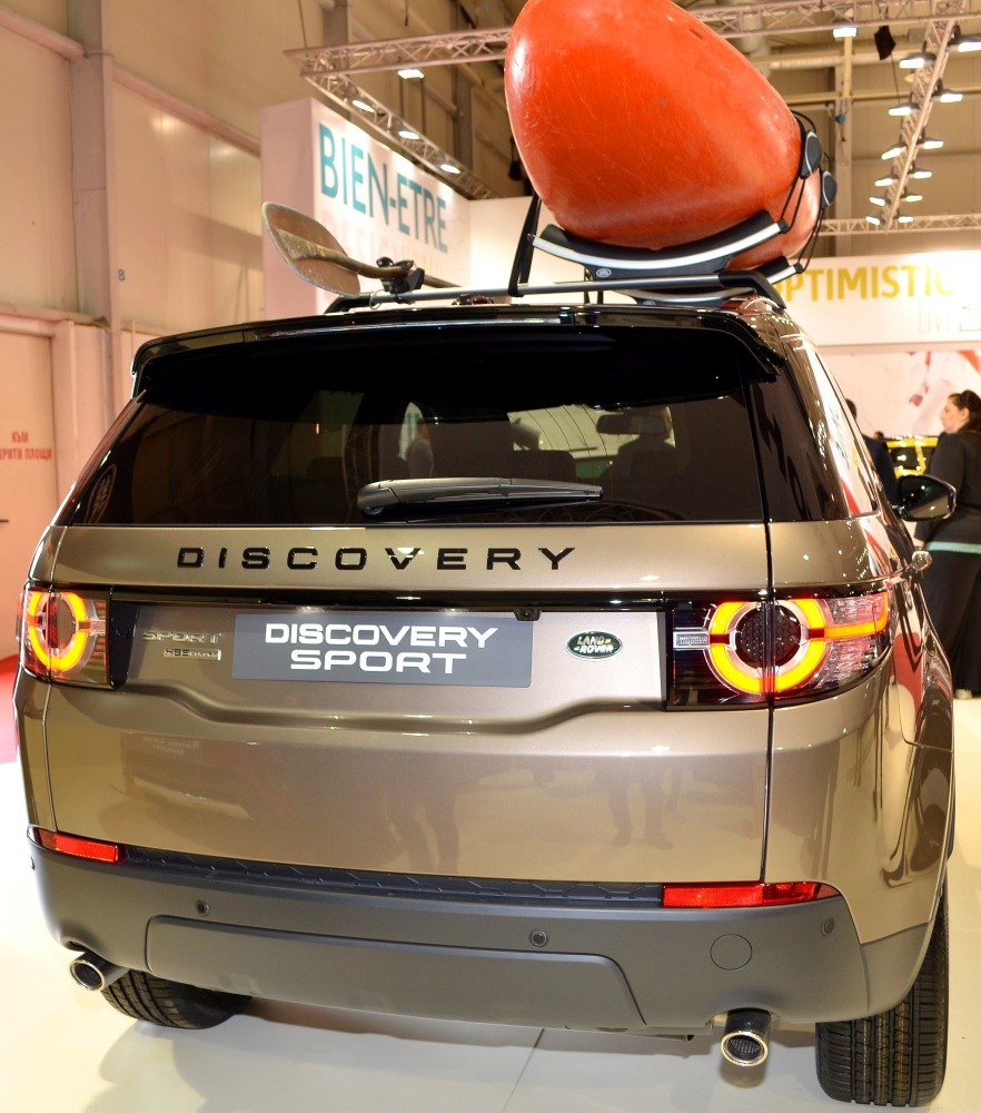 Rear view with circular LED taillights and kayak on roof rack