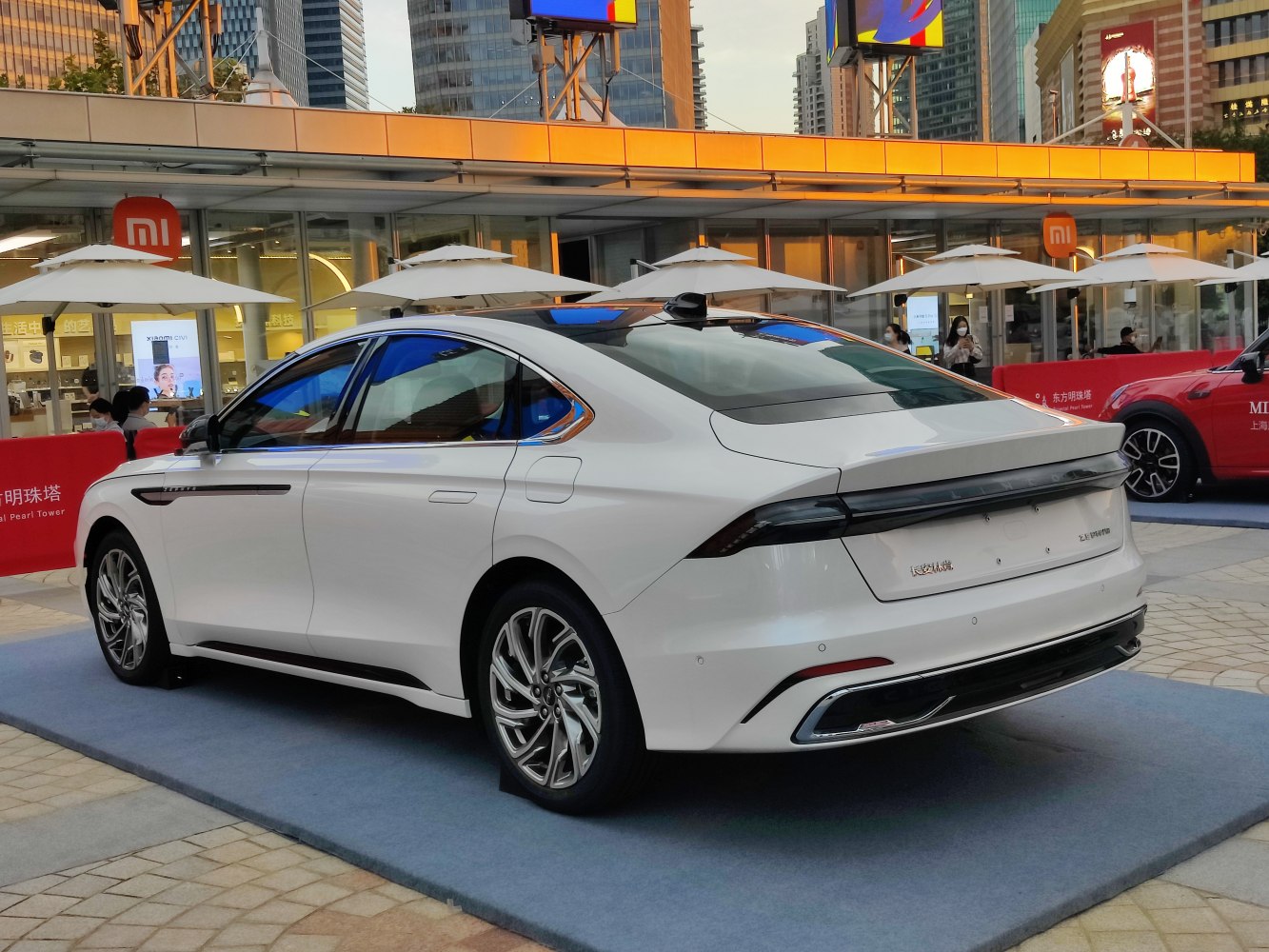 Rear and side view of a sleek white luxury sedan