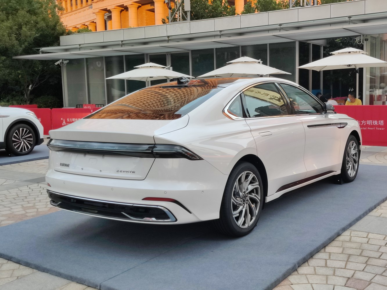 Modern luxury sedan rear with LED light bar and alloy wheels