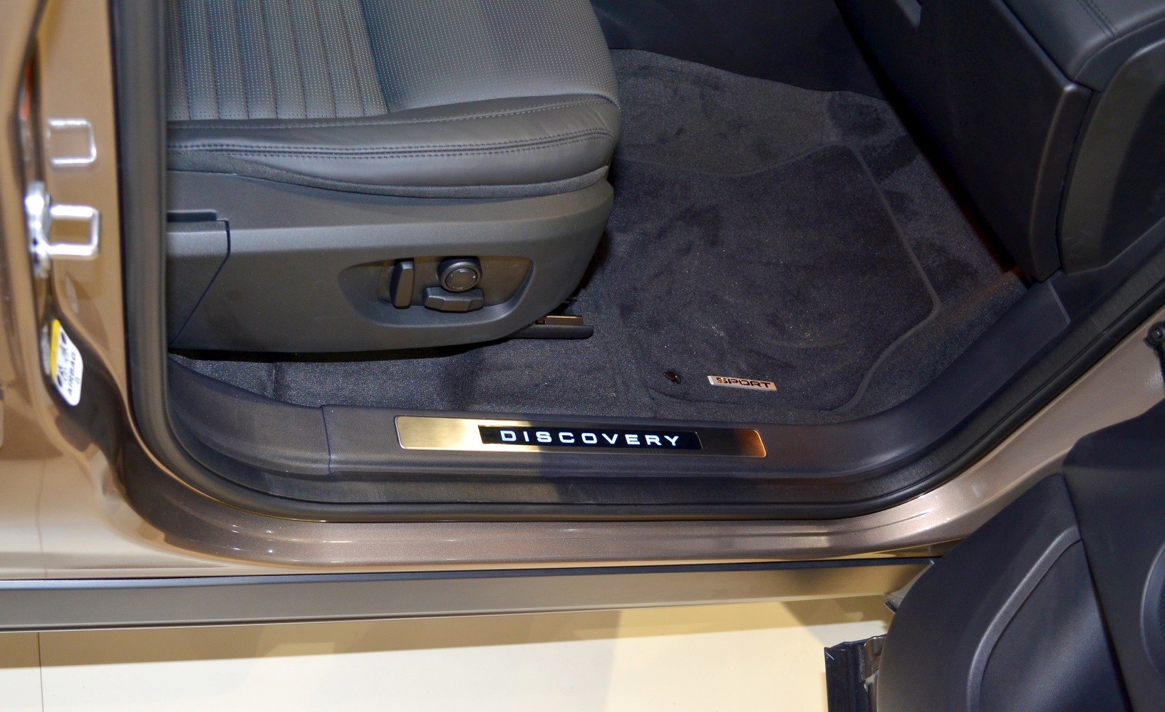 Illuminated door sill plate and leather seat with adjustment controls