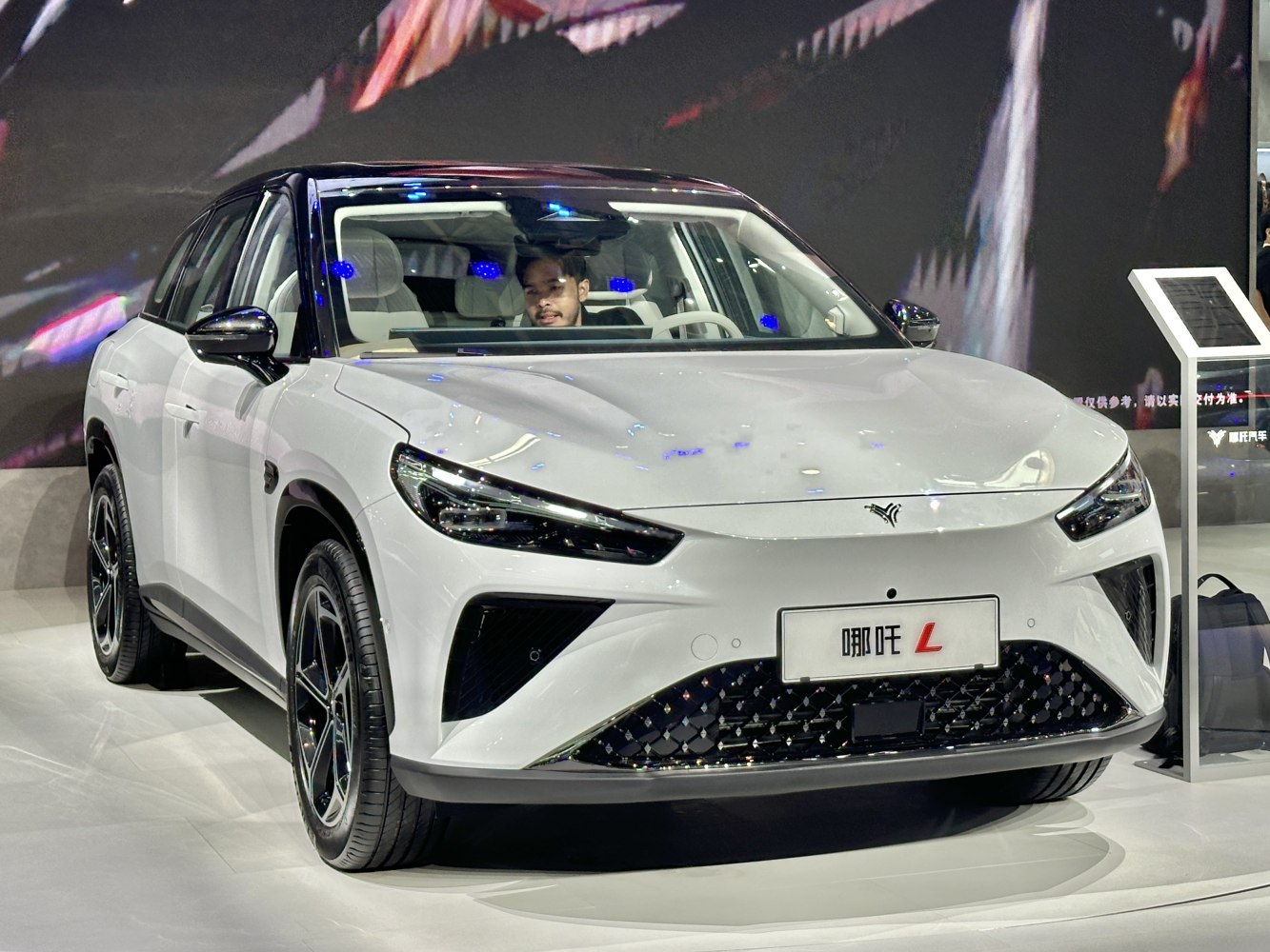 Sleek front view with aerodynamic LED headlight design on white electric SUV