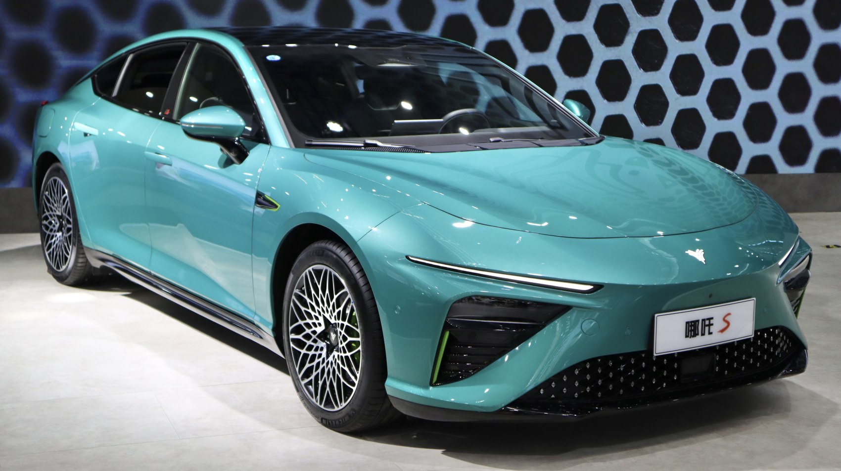 Aerodynamic electric sedan with sleek LED headlights and intricate alloy wheels