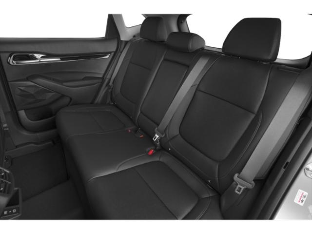 Rear black leather seats with seat belts in a modern car interior.