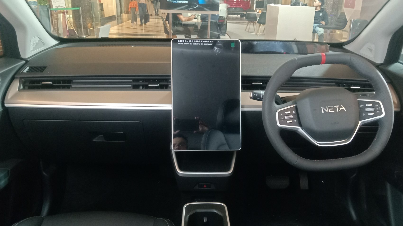 Large vertical touchscreen and multifunction steering wheel with controls