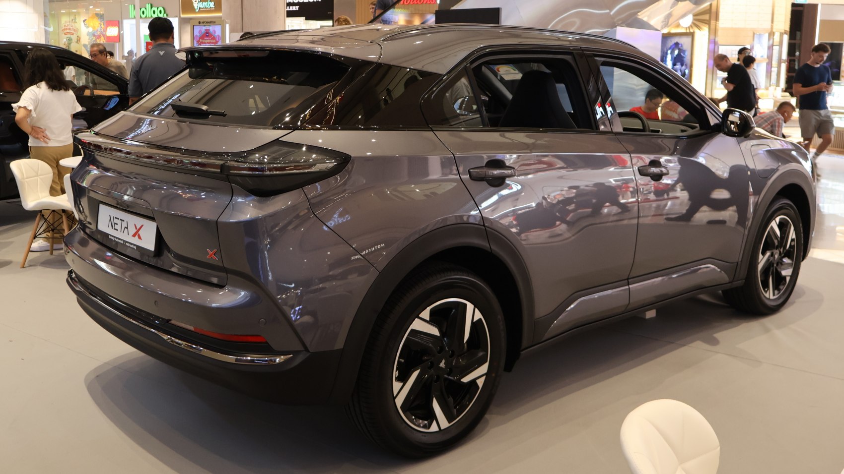 Rear and side profile of a modern electric SUV with distinctive tail lights and alloy wheels