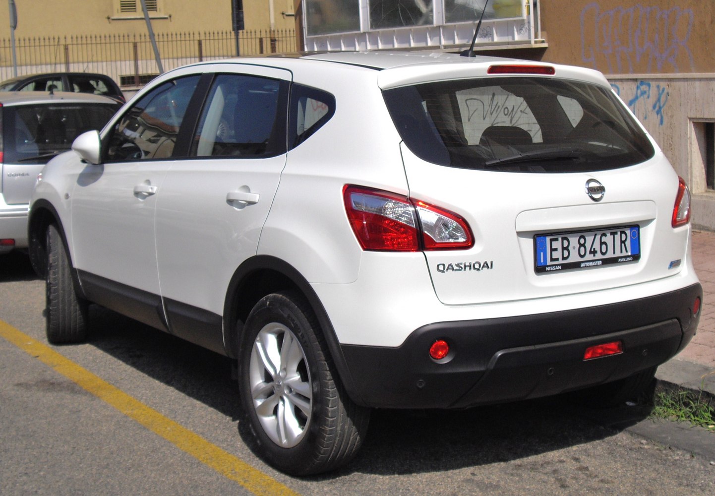 Rear-side view with taillights, rear window, and body details