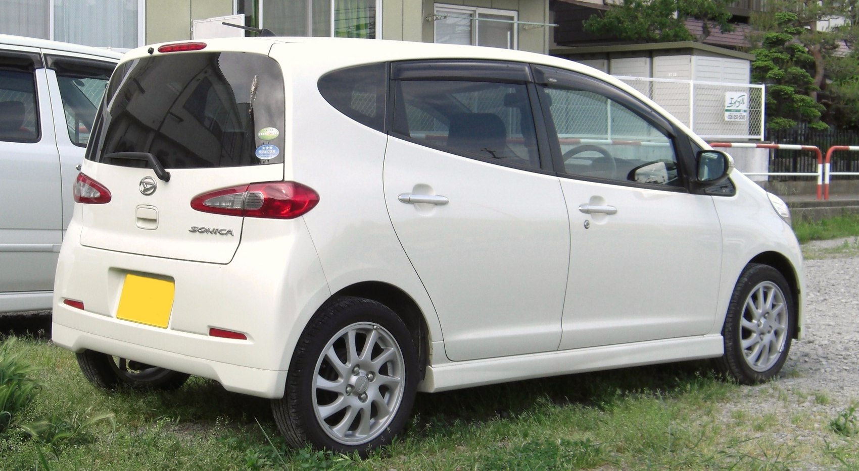 Compact hatchback side and rear view with distinctive taillights and alloy wheels