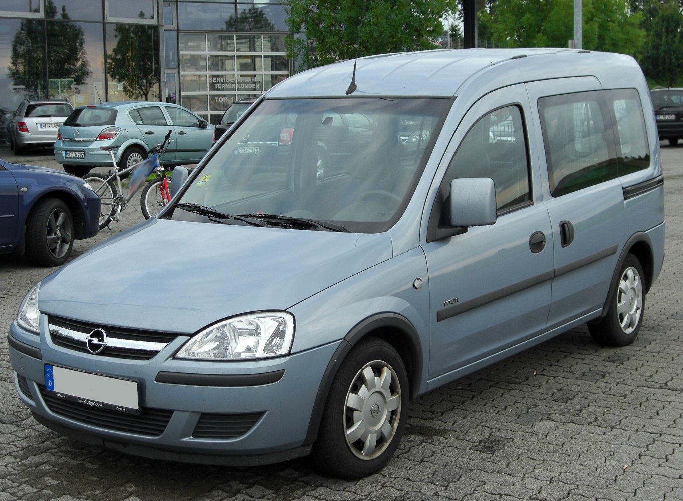 Light blue van with front angled view and sliding side door