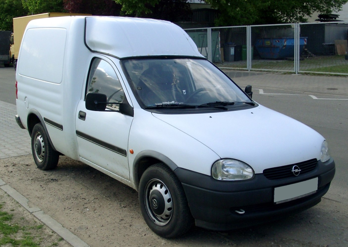 Compact high-roof van with black bumpers and round headlights