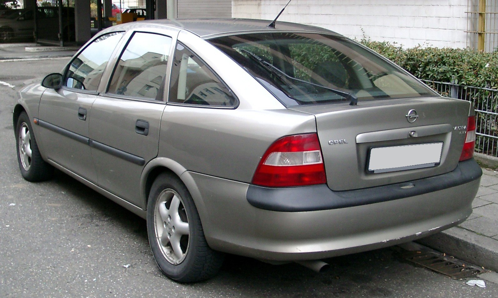 Rear three-quarter view of hatchback with distinct tail lights and wheel rims
