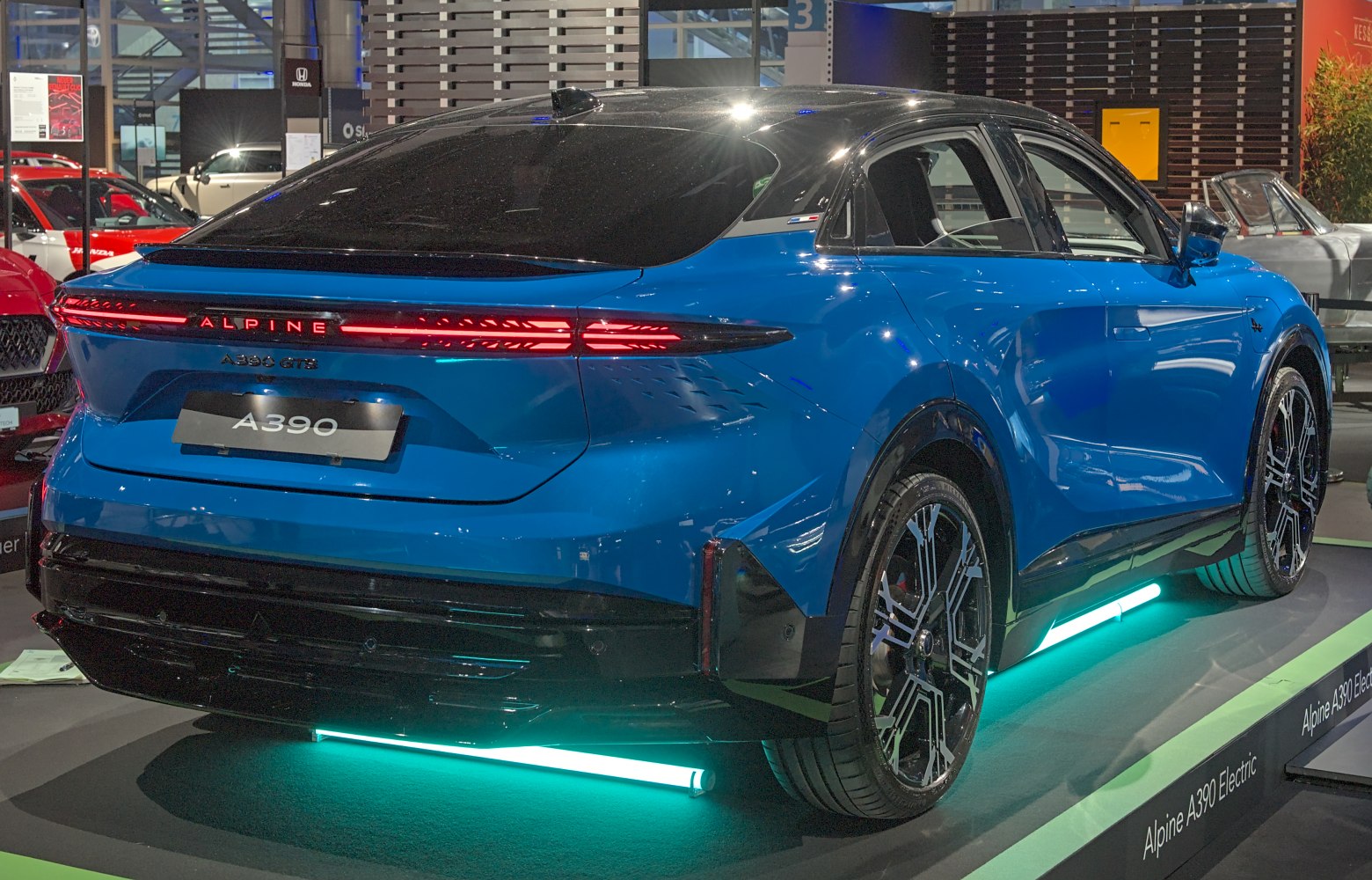 Rear view of blue electric crossover with distinctive LED taillights and unique wheels