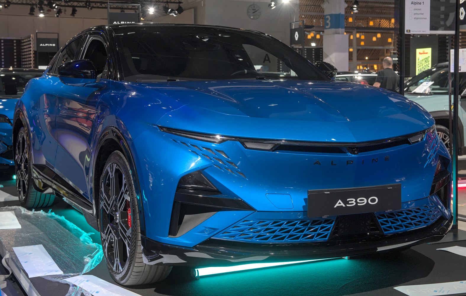 Sleek blue electric SUV with sharp LED headlights and futuristic front grille