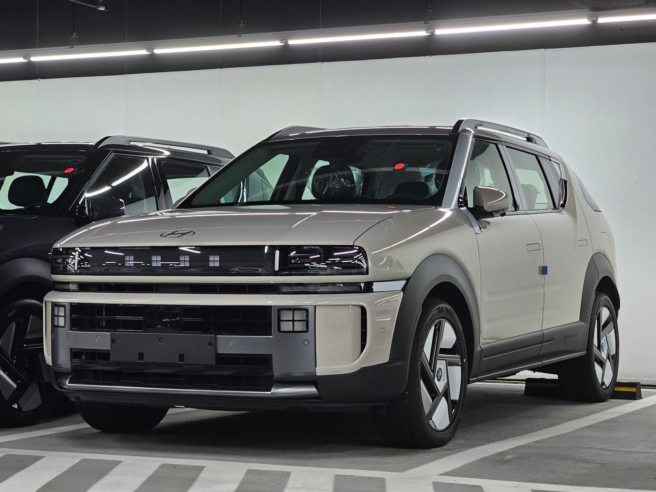 Front view of modern SUV with futuristic grille and LED headlights.