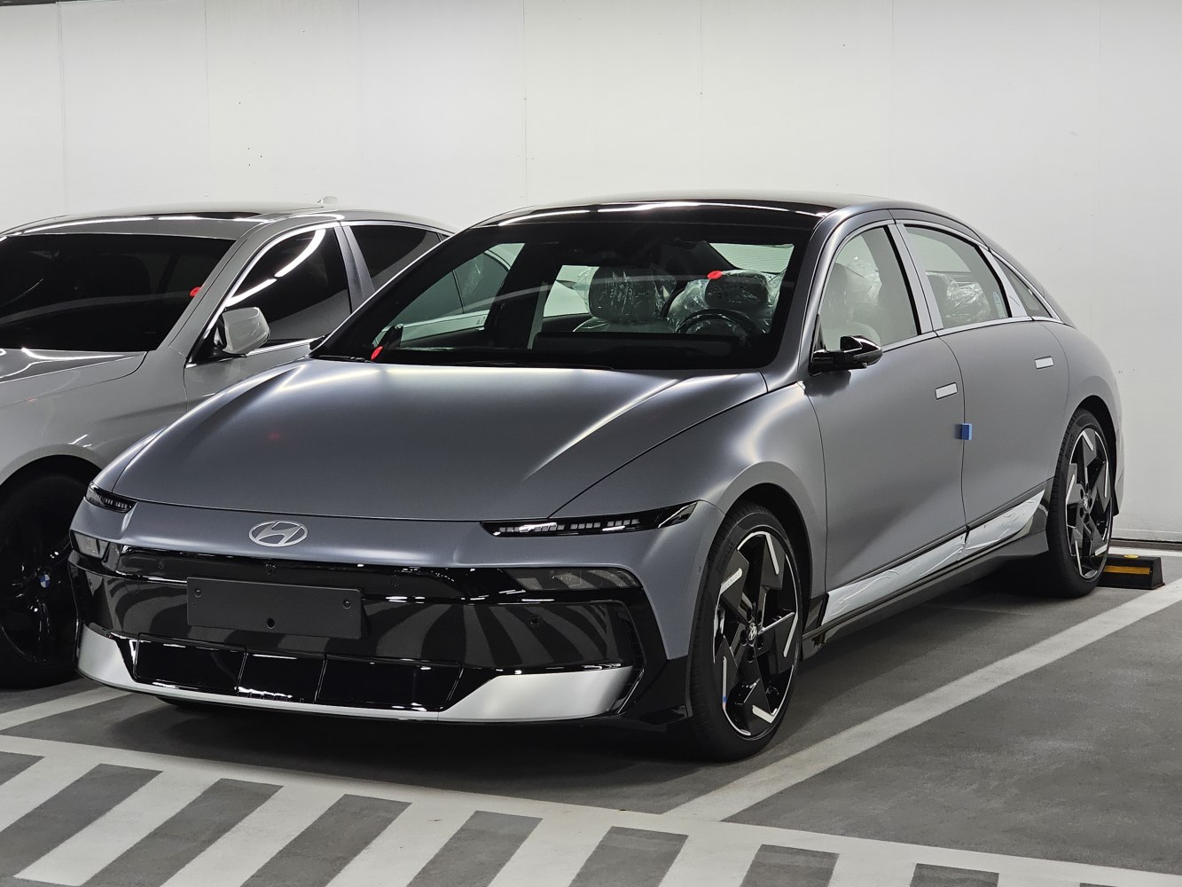 Sleek front-side view with modern headlights and aerodynamic shape