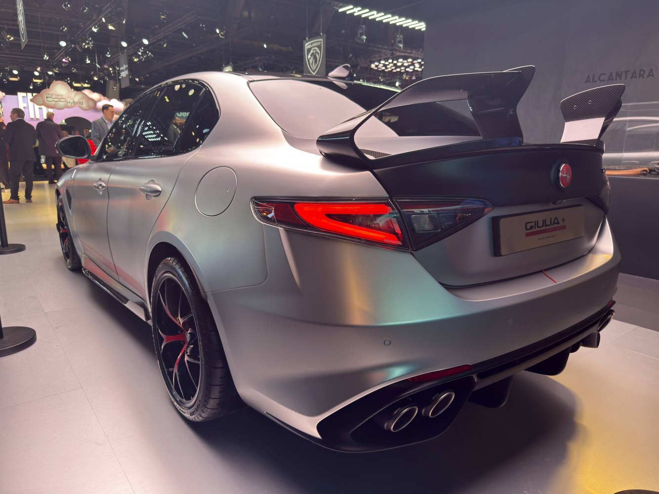 Rear view with large carbon fiber wing and quad exhaust tips