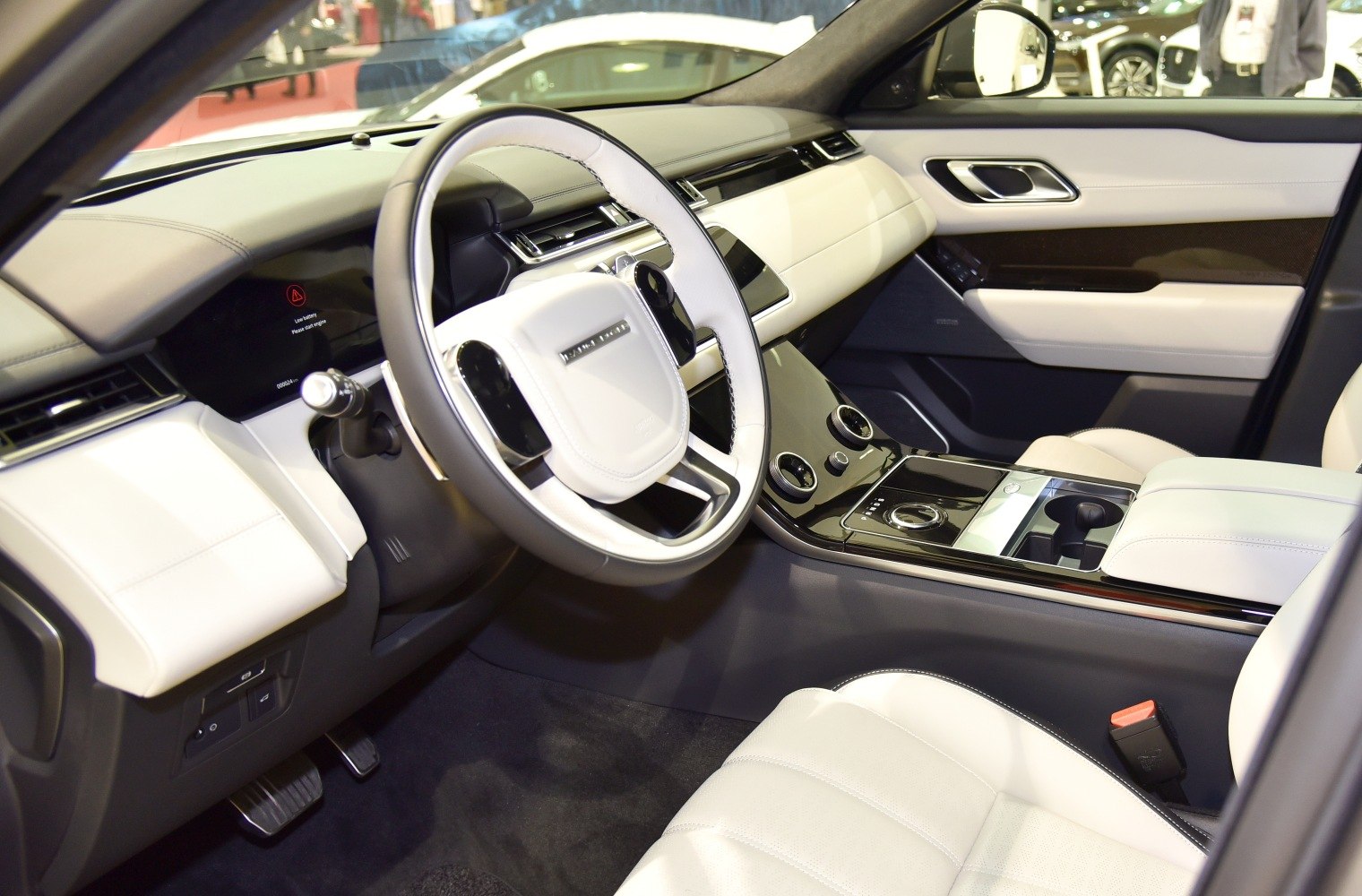 Luxurious SUV interior with advanced dashboard and white leather upholstery