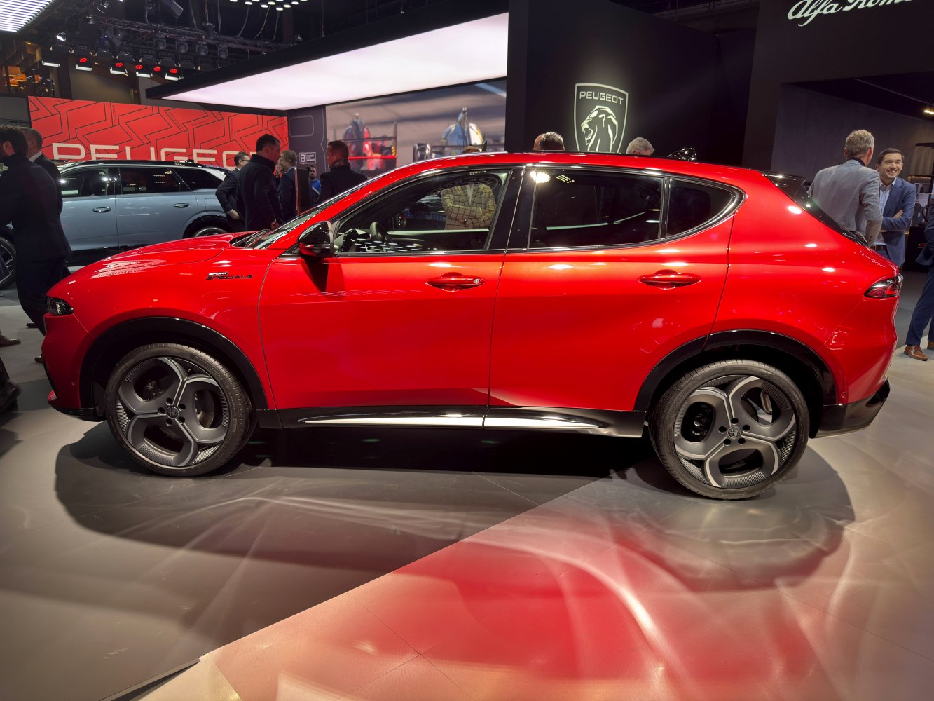 Side profile of red compact SUV with unique alloy wheels