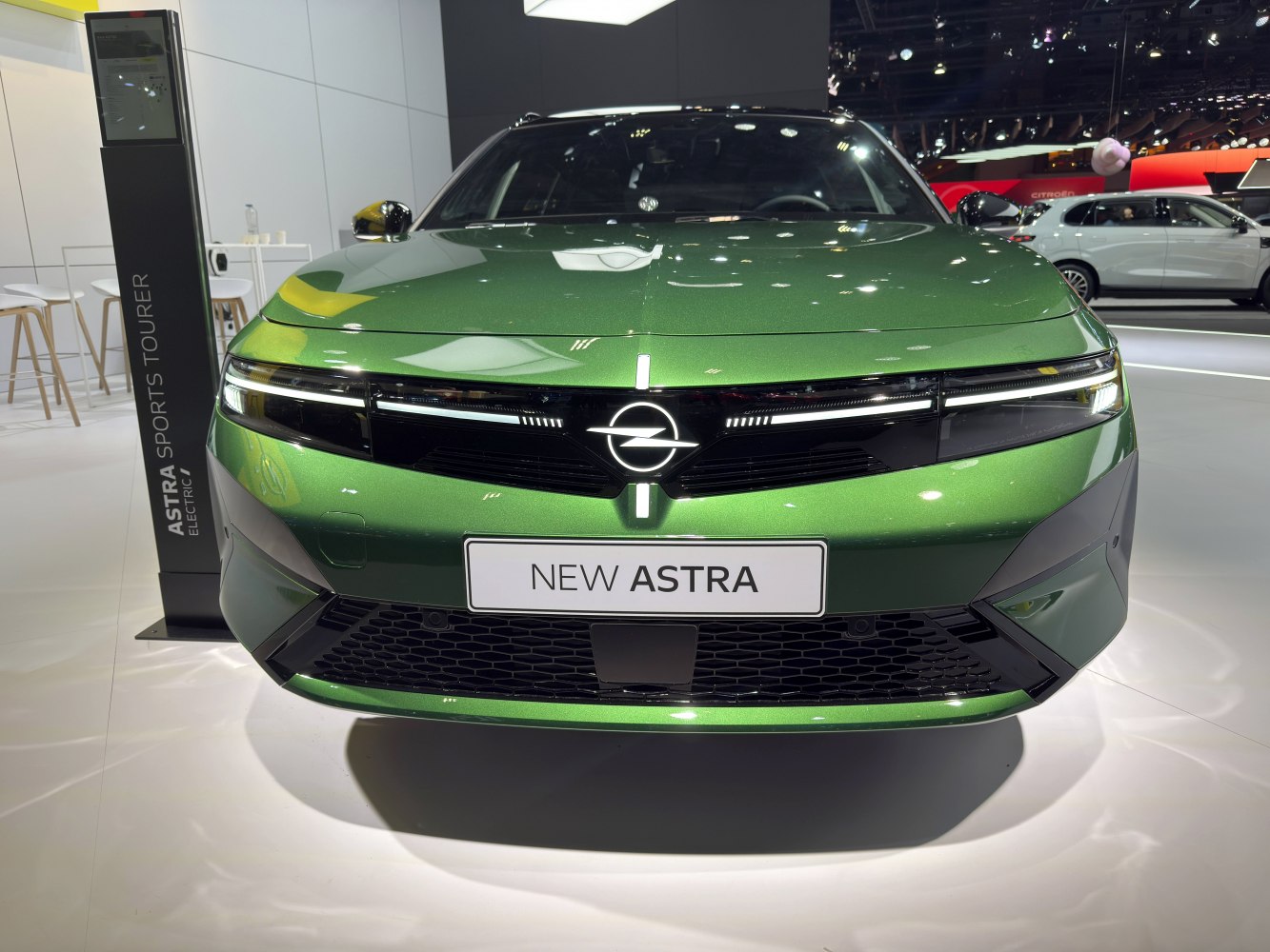Front view with LED headlights and modern grille of a green vehicle.