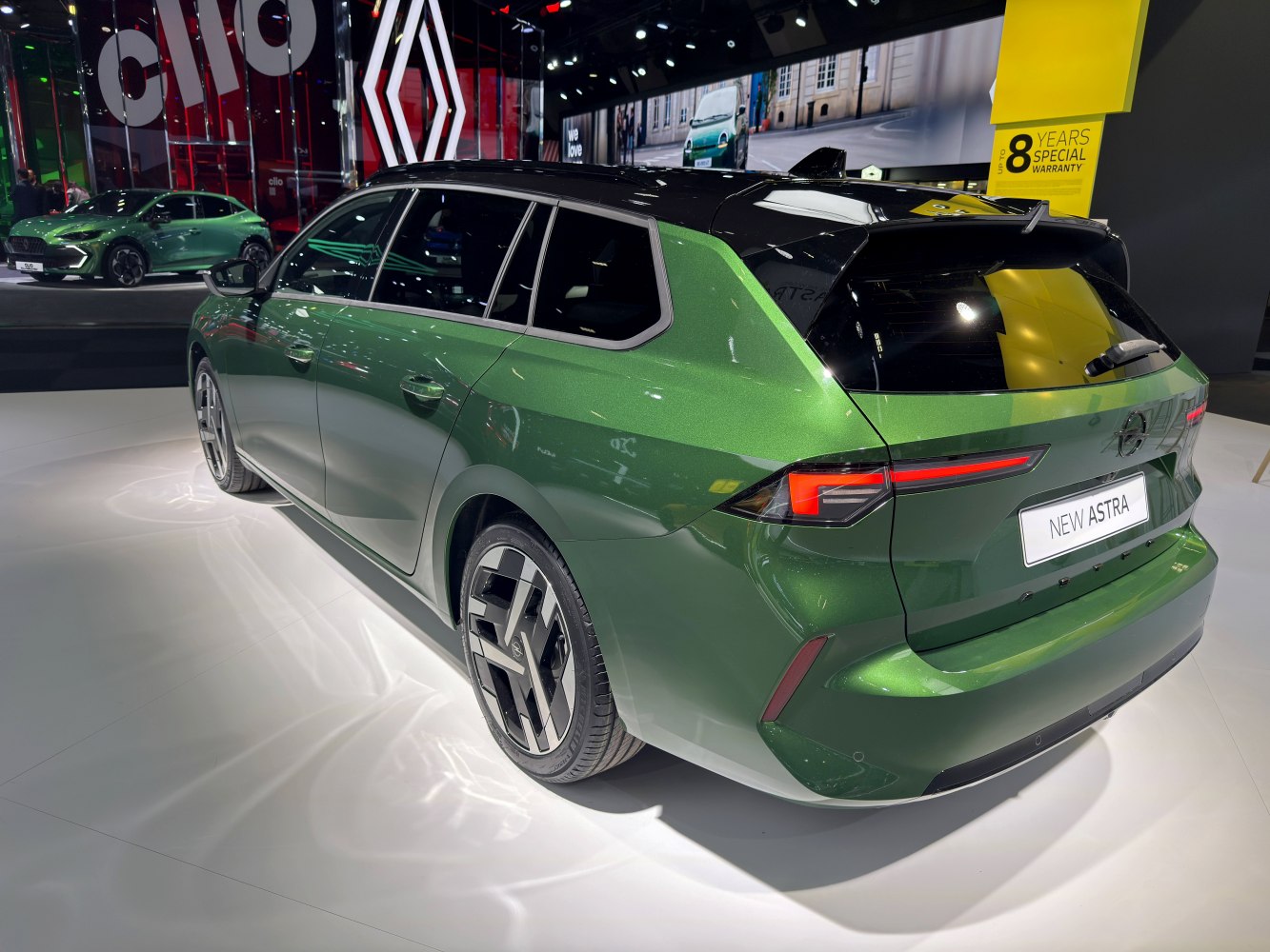 Green hatchback with black roof and futuristic taillights