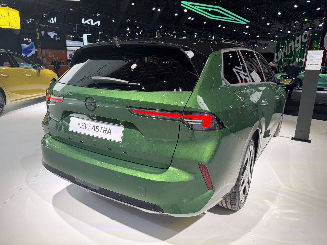 Rear view of a green hatchback station wagon with sleek modern tail lights.