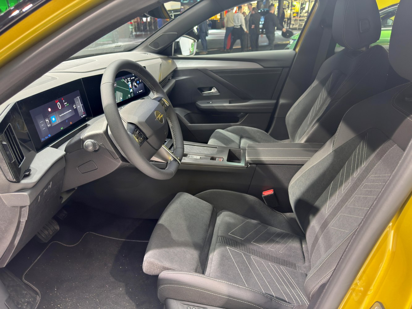 Dual digital screens and sporty front seats in a modern car interior