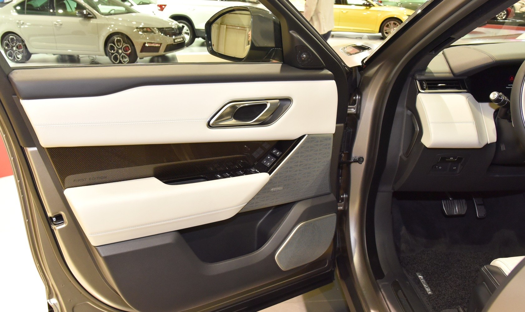 Modern car door panel with controls and foot pedals